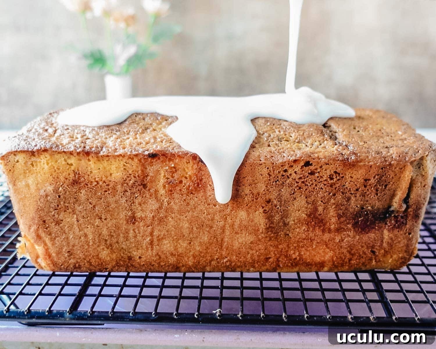 Pour lemon glaze on cooled lemon blackberry loaf.
