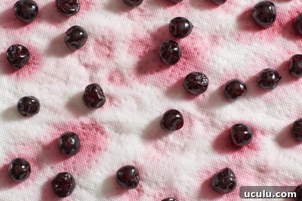 Cocktail cherries draining on a paper towel.