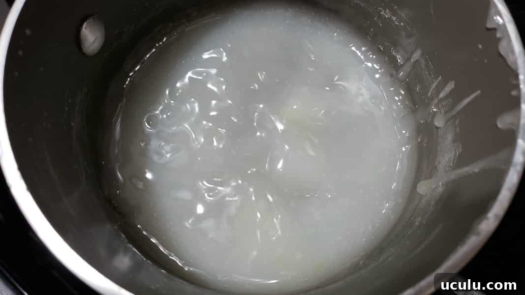 cornstarch, sugar, salt, and water cooking in a pan.