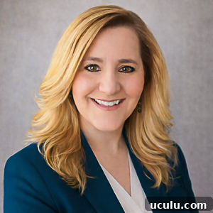 a professional portrait of zona house wearing a teal blazer.