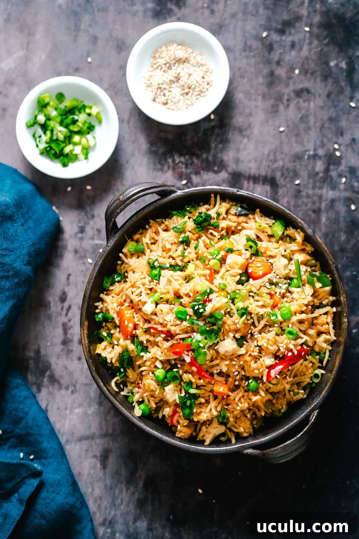 overhead shot it a bowl with vegan instant pot teriyaki fried rice topped with green onions and sesame seeds