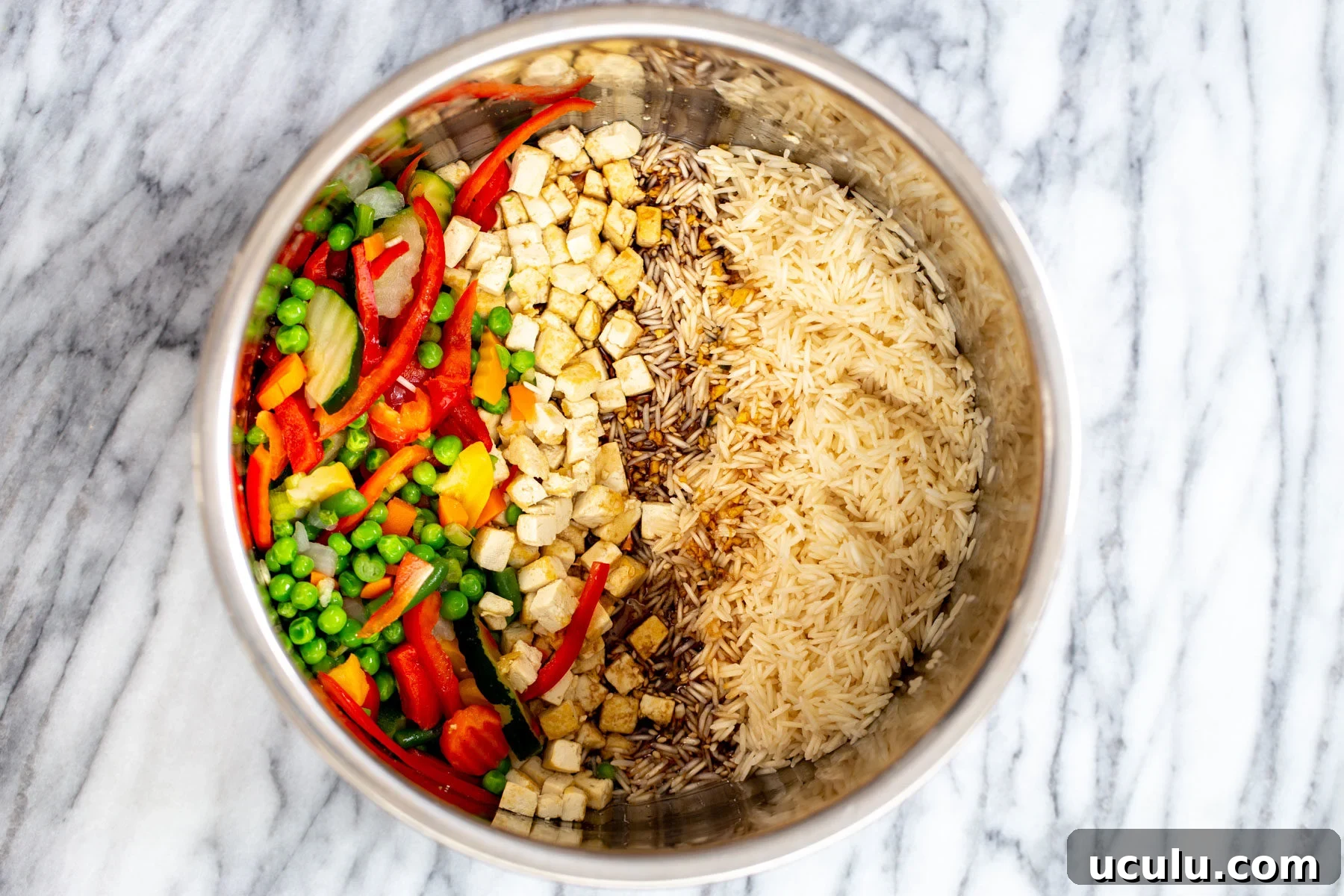 rice being mixed with teriyaki sauce, vegetables and tofu in an Instant Pot