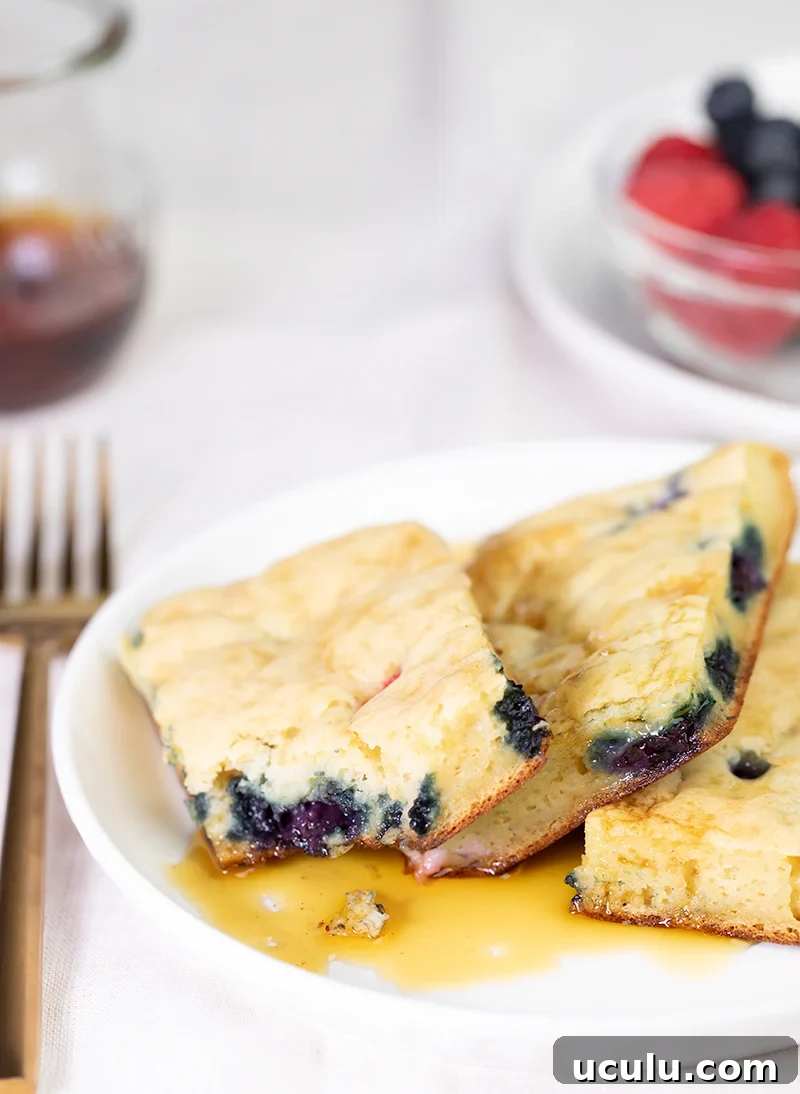 3 slices of sheet pan pancakes with bite taken from one