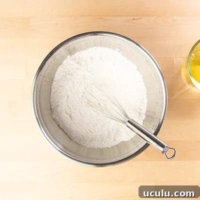 Pancake dry mix in metal bowl with whisk