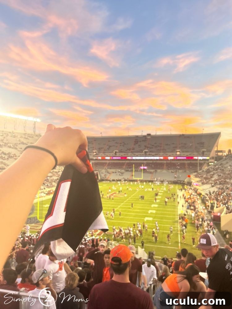 View from student section at Lane Stadium with a student holding up a spirit towel.