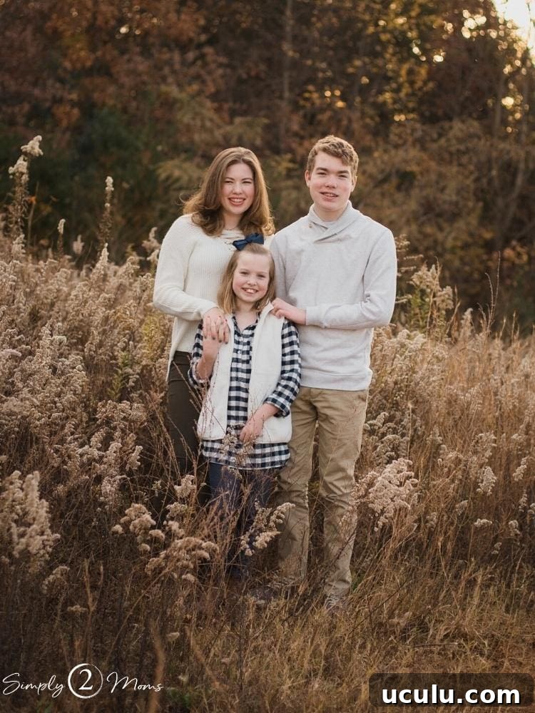 Three siblings wearing neutral tops plus one buffalo check plaid tunic for fall photo session.