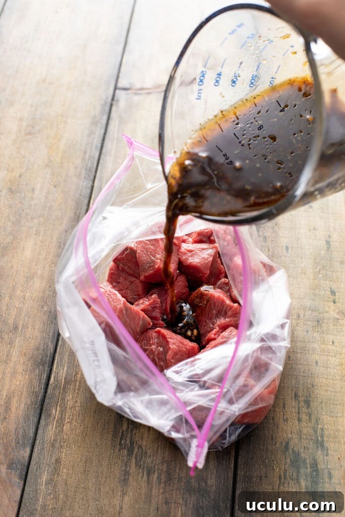 pouring the marinade over the steak tips