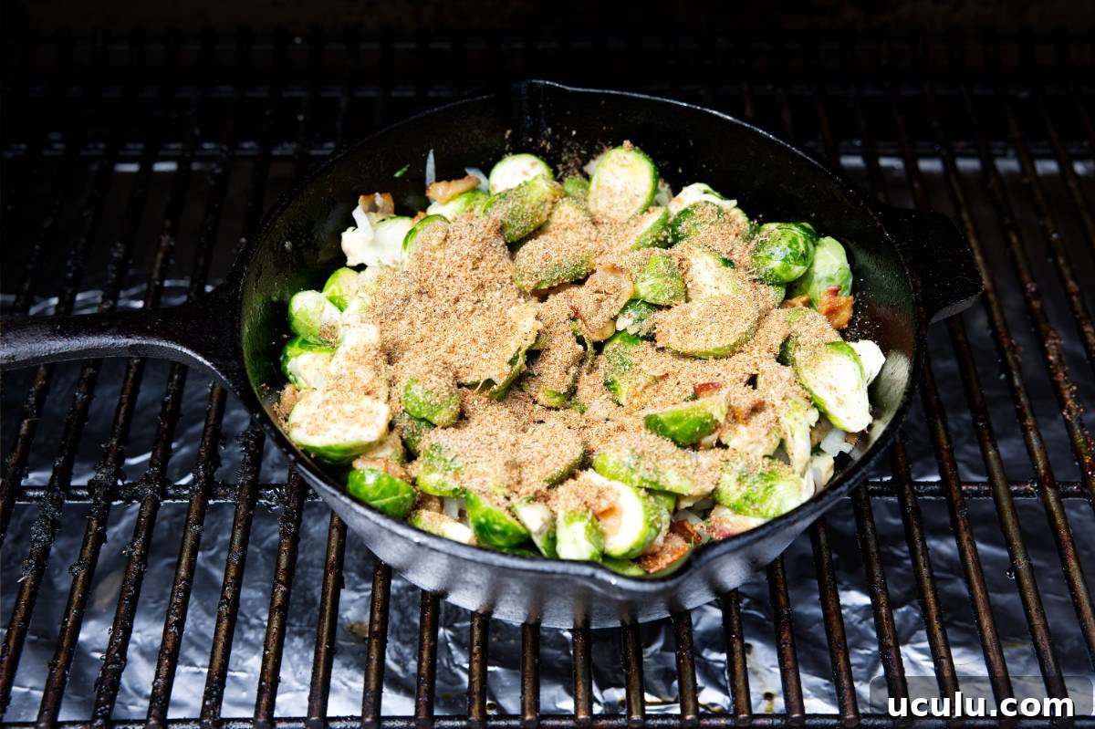 brussels sprouts in a skillet with seasoning sprinkled on top