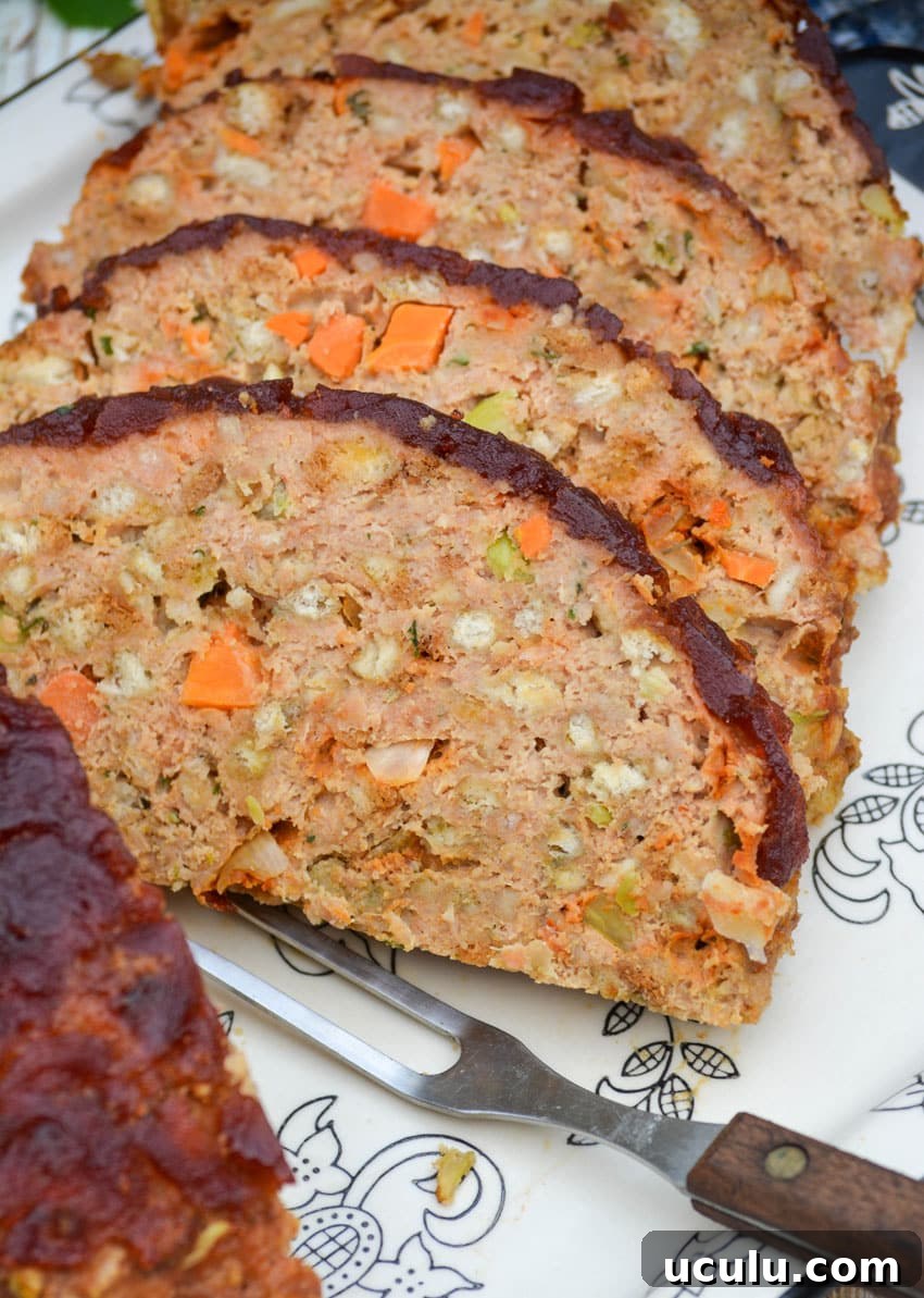 slices of Thanksgiving meatloaf arranged on a serving platter next to a meat fork