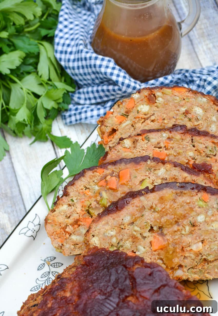 slices of Thanksgiving meatloaf arranged on a serving platter next to a meat fork