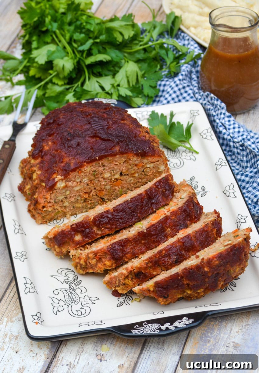 slices of Thanksgiving meatloaf arranged on a serving platter next to a meat fork
