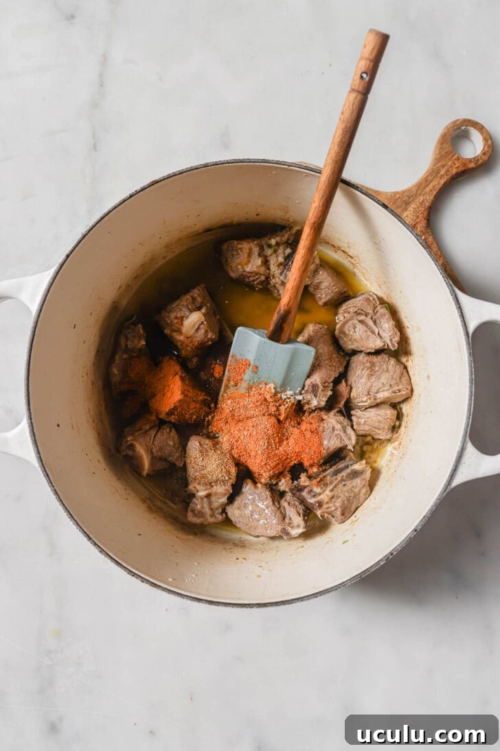 Ground spices added to browned mutton.