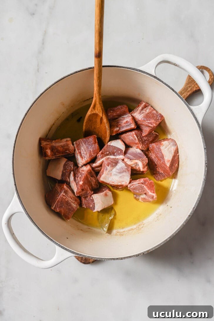 Mutton added to sautéed whole spices.