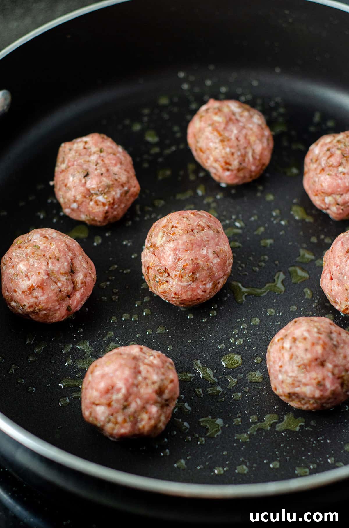 meatballs browning in a skillet