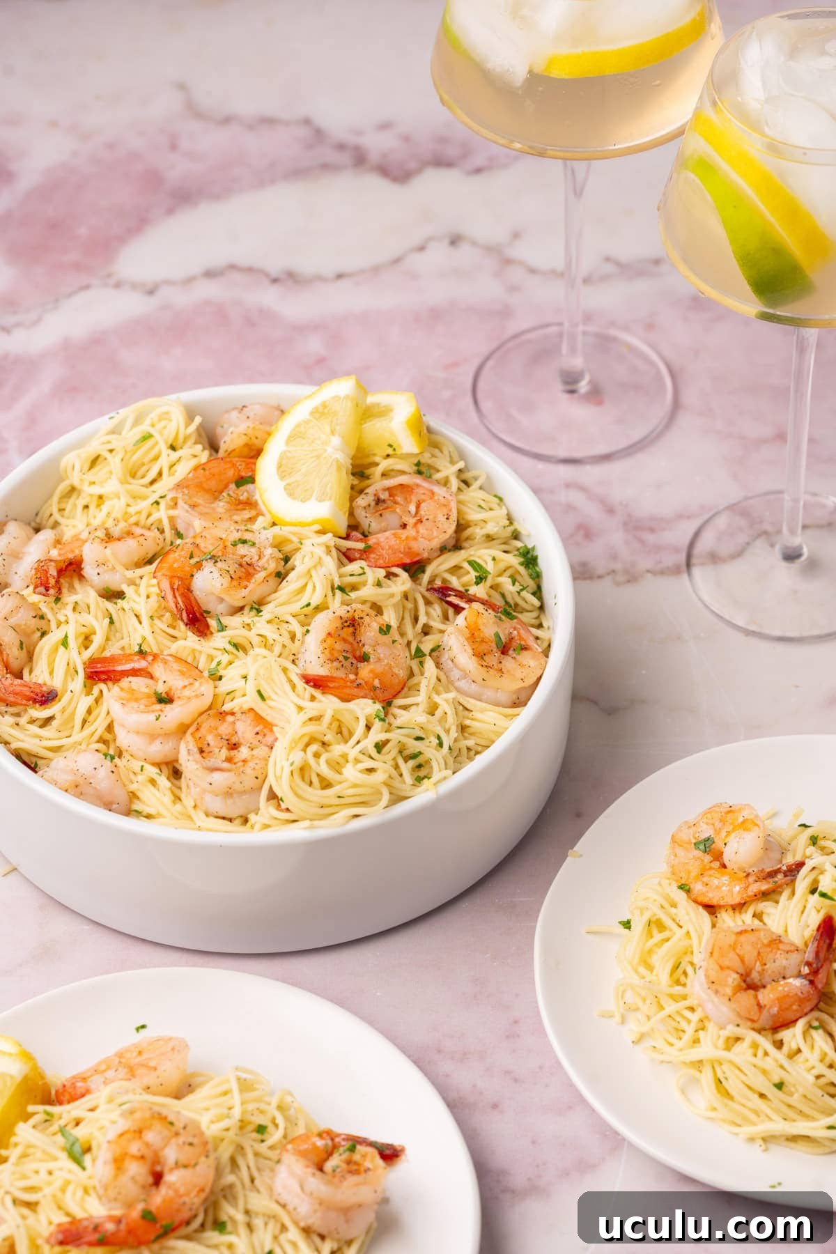 Shrimp Lemon Pasta in a serving bowl with a small serving on a plate. 