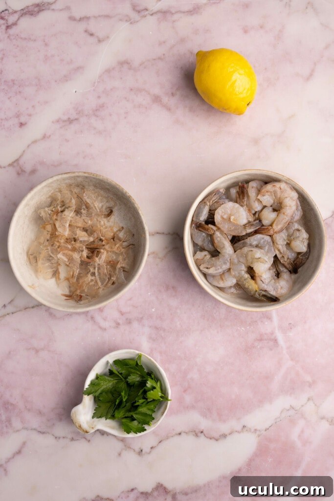 Peeling shrimp but leaving the tails on.