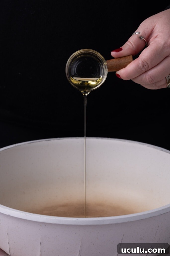 Getting oil hot in a pan before adding the shrimp. 