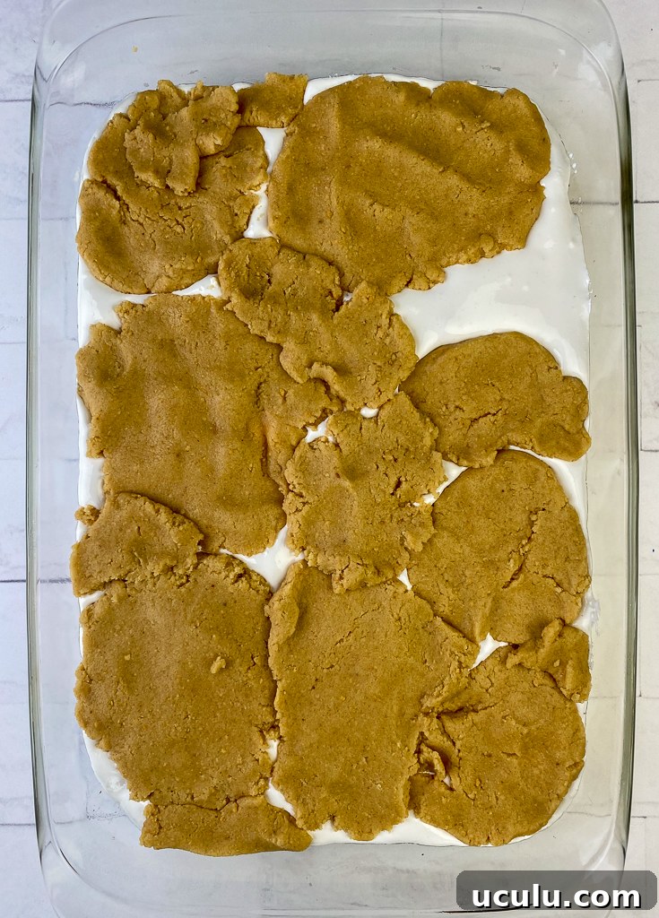 Showing how to make pieces of graham cracker baking mixture to make the top layer of the cake