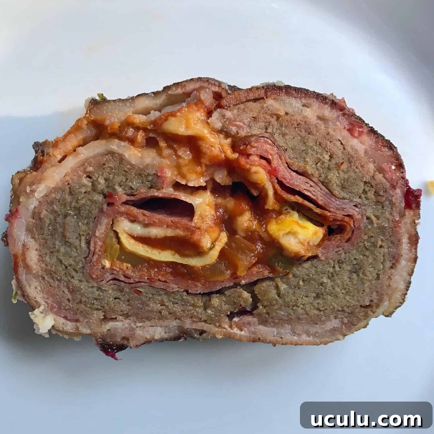 Pizza Bacon Explosion slice on white background overhead shot