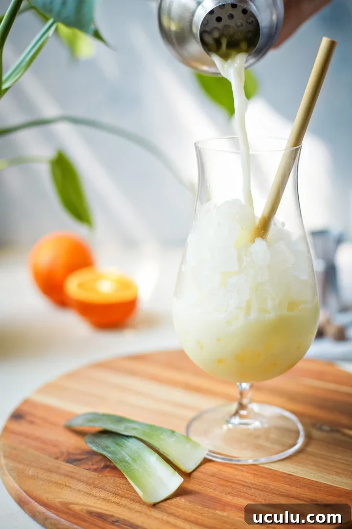woman pouring a painkiller cocktail into a glass
