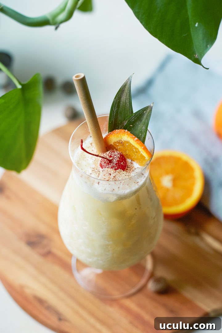 close up of a painkiller drink in a glass with straw