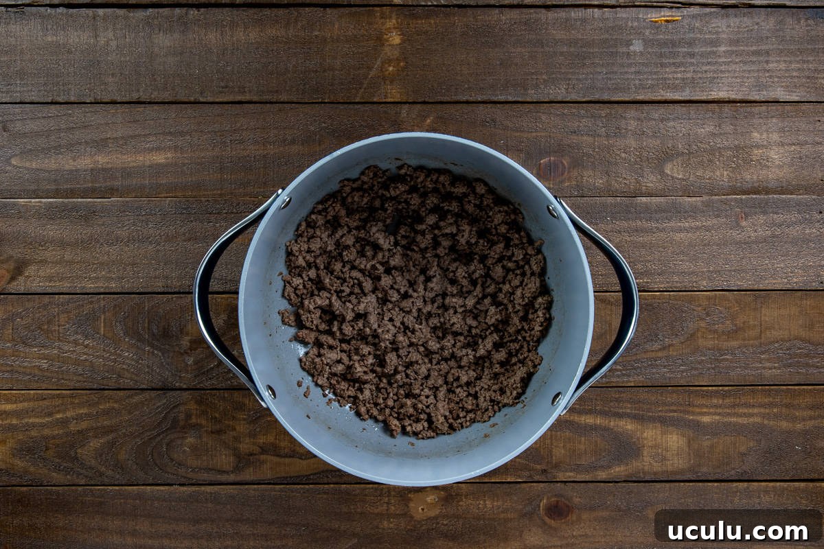 Cooked and drained ground beef in a large pan.