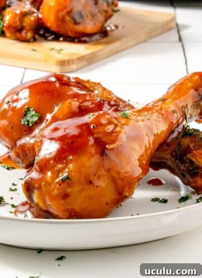 Two pieces of BBQ chicken Legs in air Fryer on a plate.