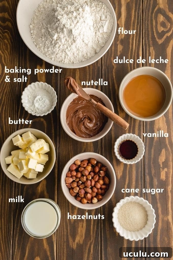 Ingredients to make Nutella buns labelled and arranged on a wooden surface.