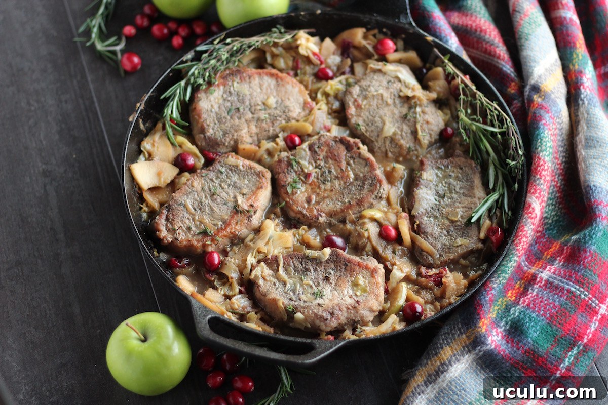 Apple Cranberry Skillet Pork Chops (AIP, Paleo) - a festive holiday pork dish featuring cranberries, apples, cabbage, onions, and fresh herbs! Simple and delicious! | fedandfulfilled.com