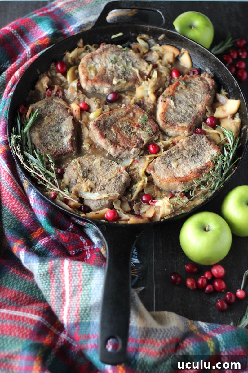 Apple Cranberry Skillet Pork Chops (AIP, Paleo) - juicy pork, sauteed apples, cranberries, cabbage, and onions come together for an easy and tasty main course! | fedandfulfilled.com