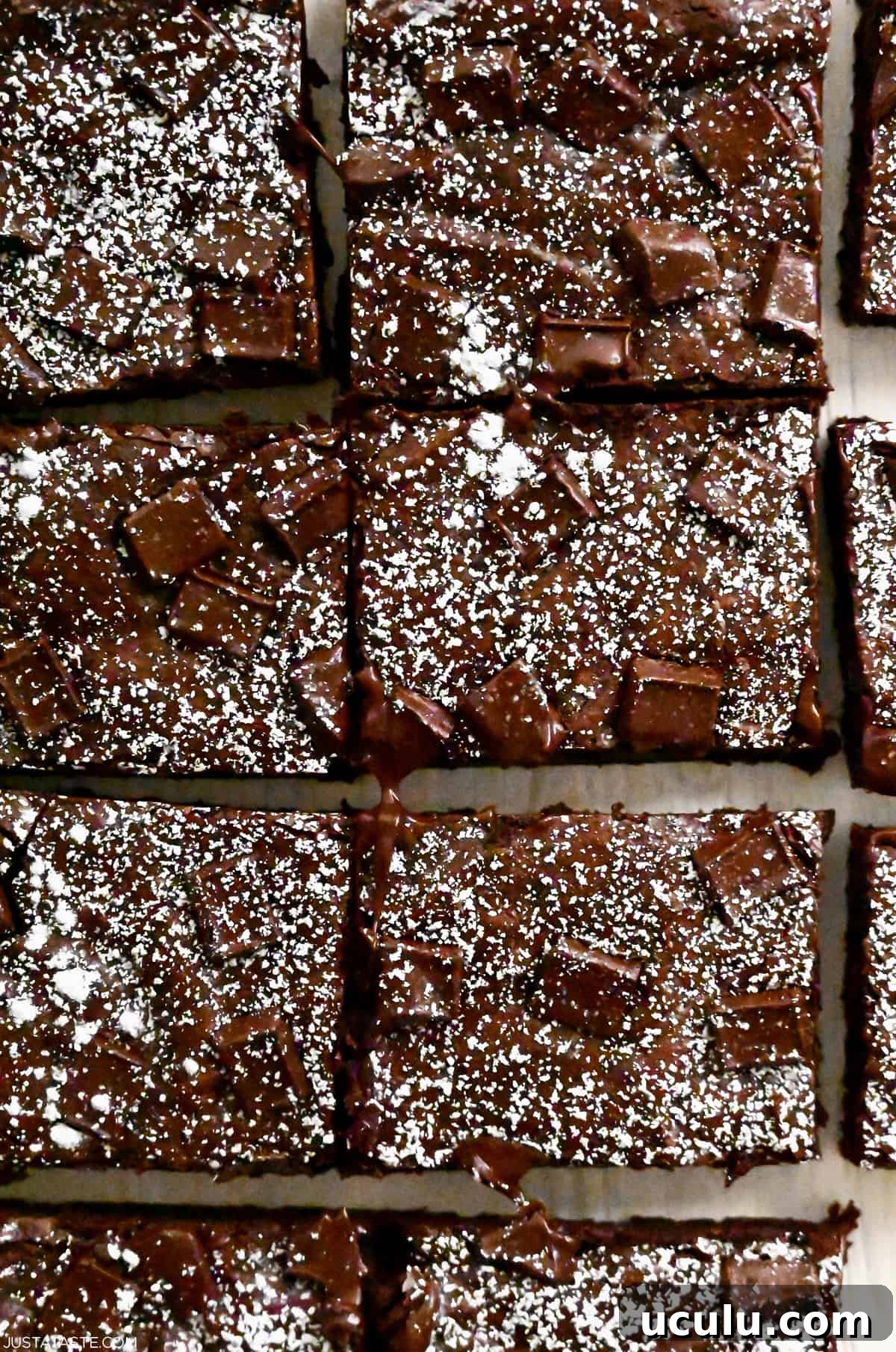 Brownies cut into perfect rectangles and dusted with powdered sugar.