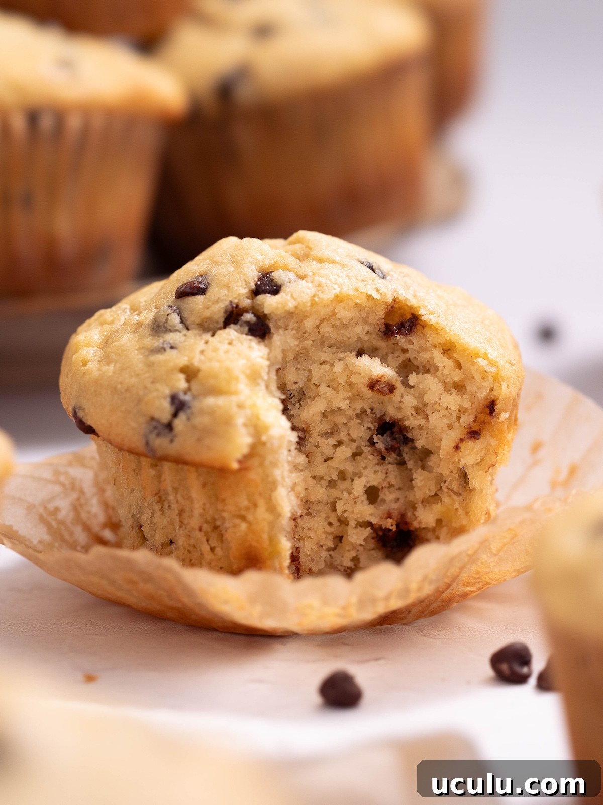 A sourdough discard banana muffin with a bite taken out of it