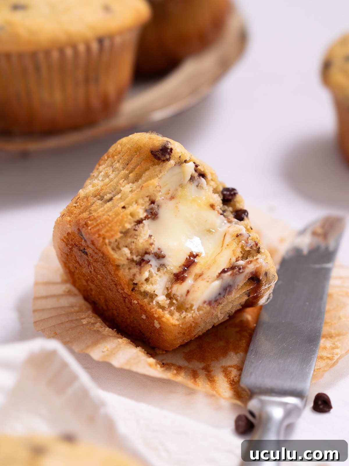 A fresh muffin, cut open and smeared with melty butter