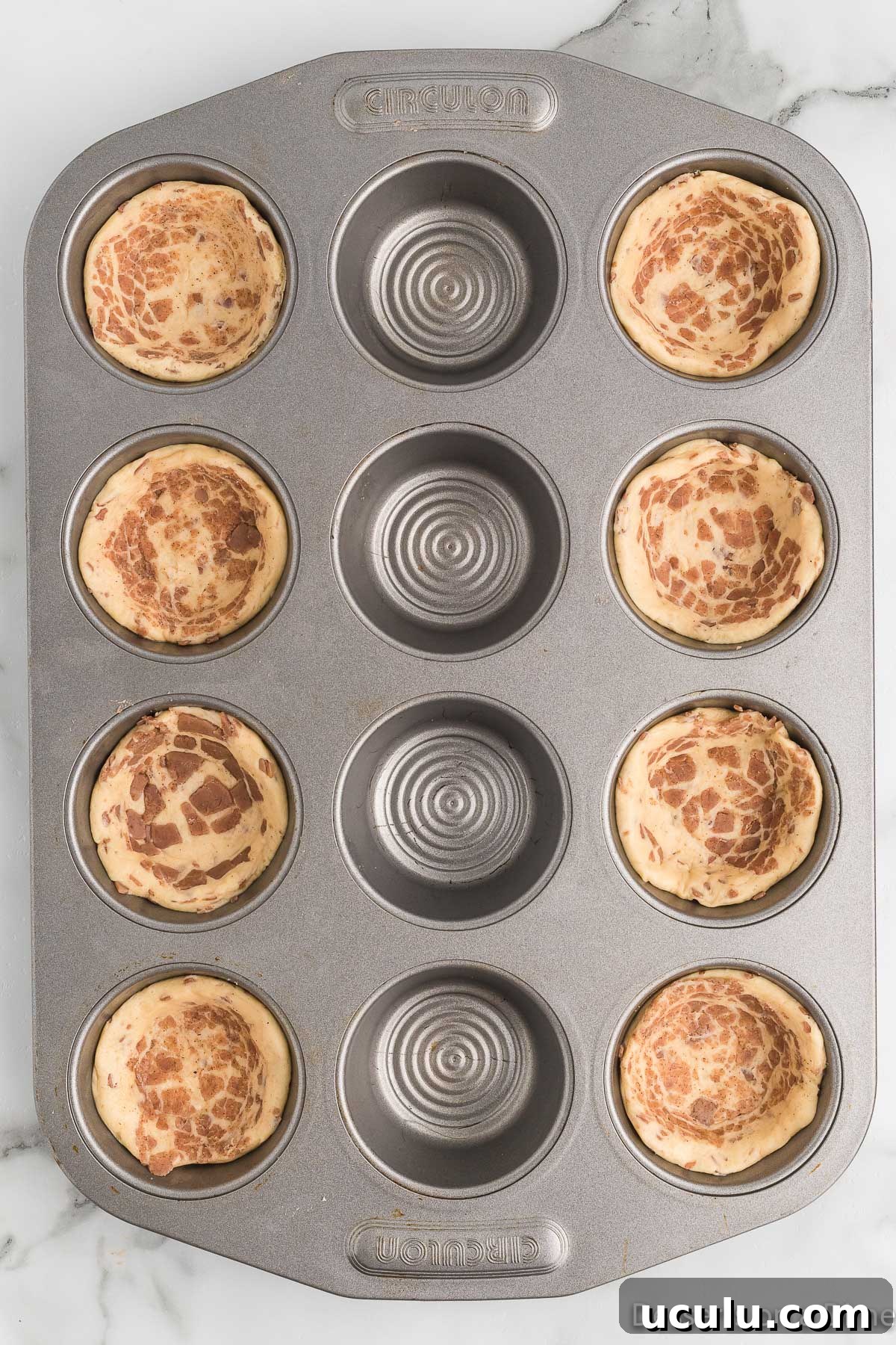 Cinnamon rolls in muffin tin.