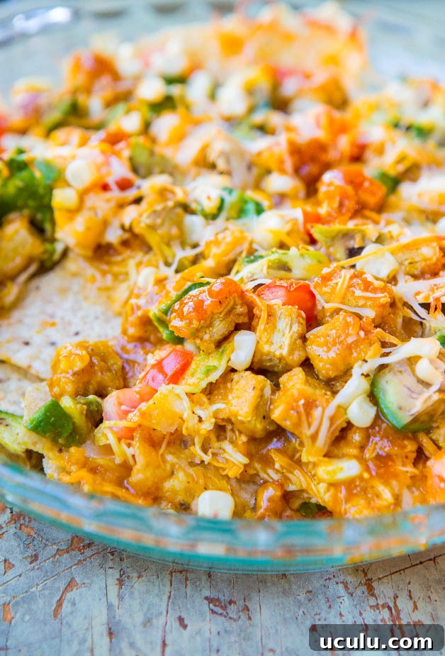 Loaded BBQ Chicken Nugget Nachos (with vegan/GF options) - Chicken nuggets coated in BBQ sauce on top of cheesy nachos. Perfect party food!