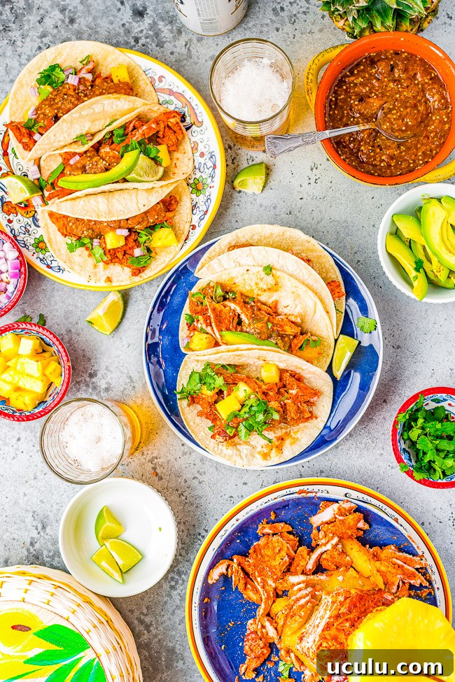 Tacos Al Pastor - Learn to make this staple Mexican recipe that includes thinly sliced pieces of pork marinated in a tangy, sweet pineapple sauce AT HOME!  Juicy, flavorful, tender pork served in tortillas with onions, cilantro, lime juice, and salsa! You'll want every night to be taco night! 