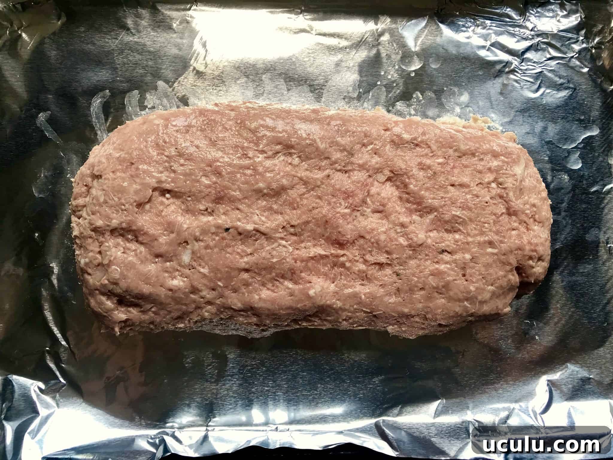 Gyro Meat formed into loaf on baking sheet reading to be cooked