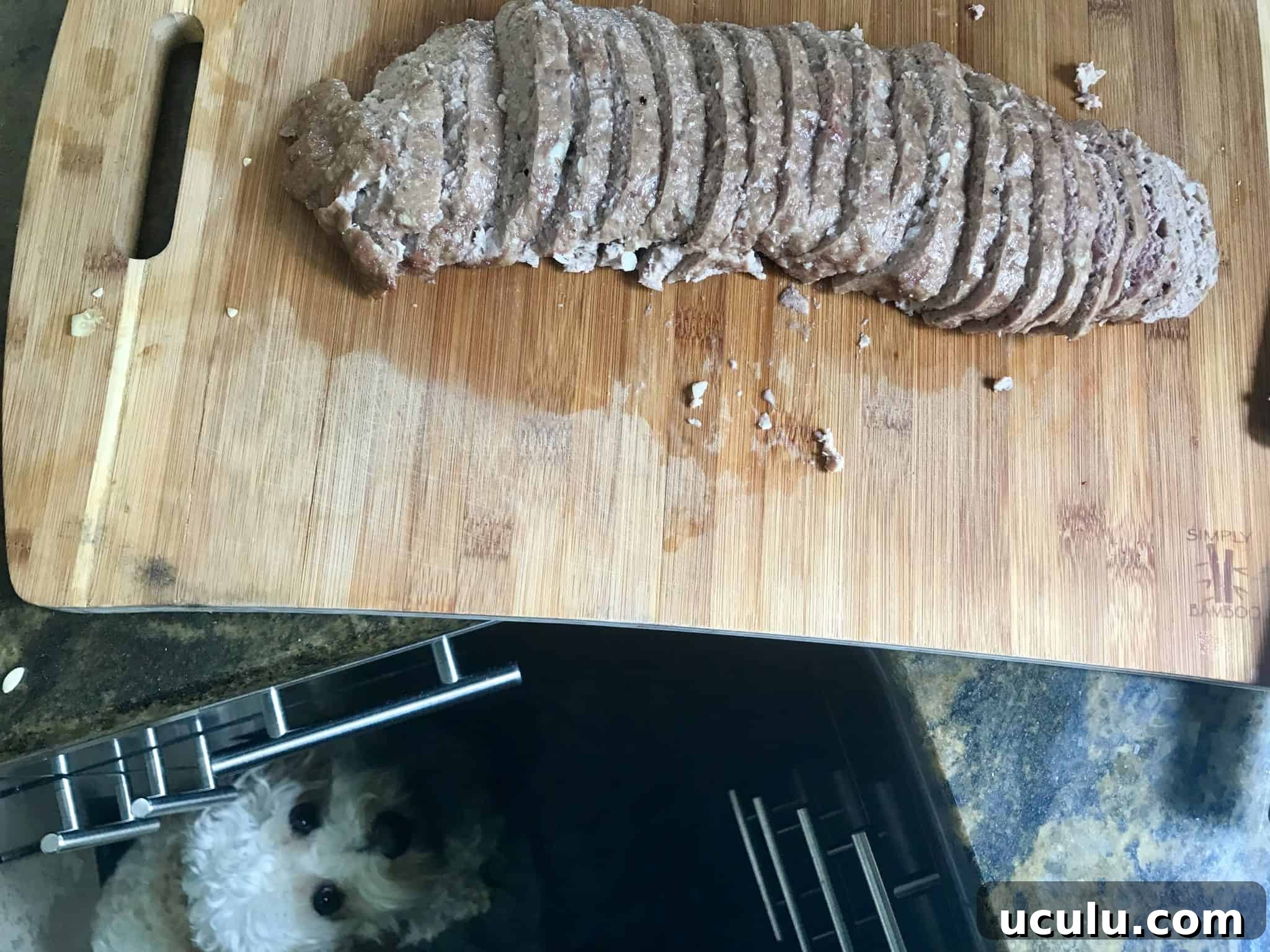 Gyro Meat sliced on cutting board with dog eyeing it