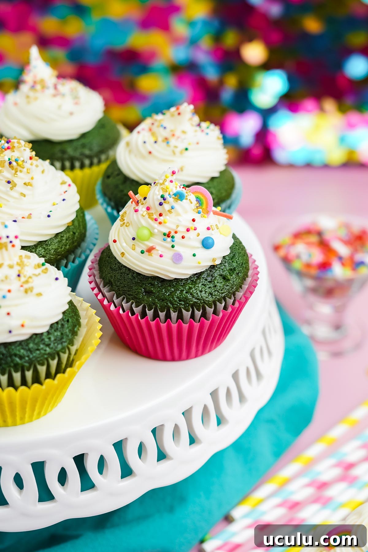 St. Patrick's Day cupcakes on a white cake stand.