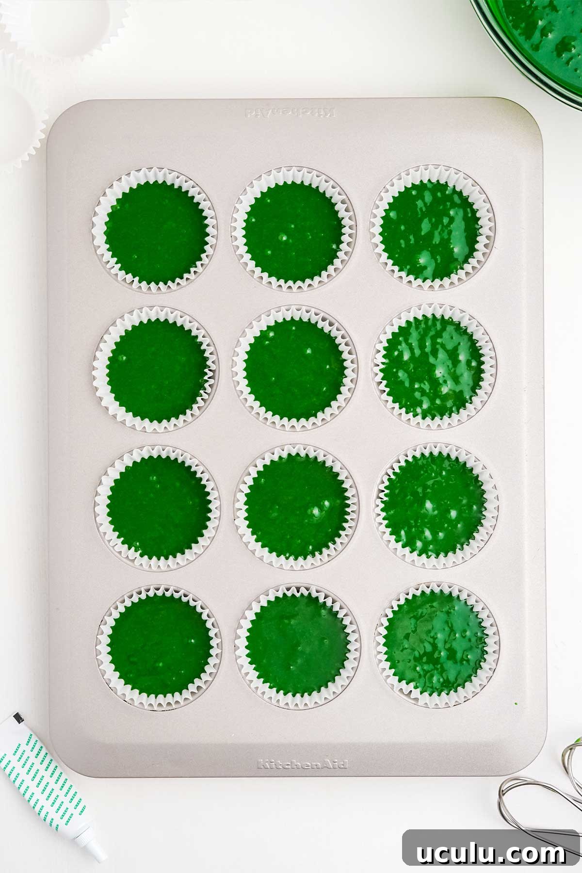 Batter for St Patrick's Day cupcakes poured into cupcake pan.