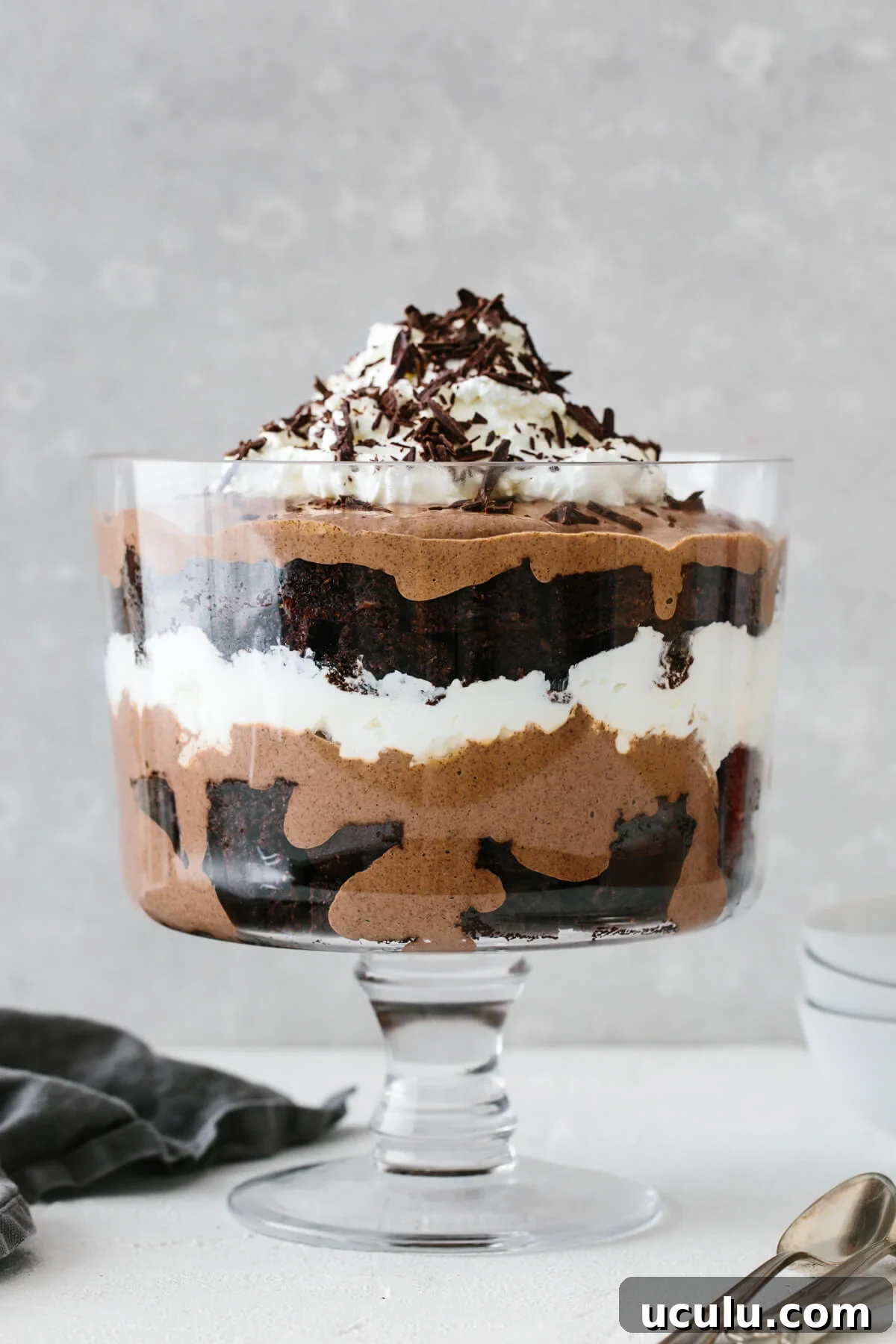 A layered brownie trifle in a trifle bowl.