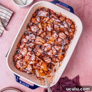 cinnamon roll with apple pie drizzled with creamy glaze.