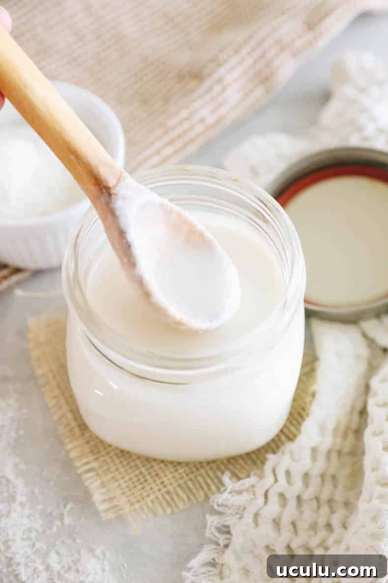drippy coconut butter on a wooden spoon.