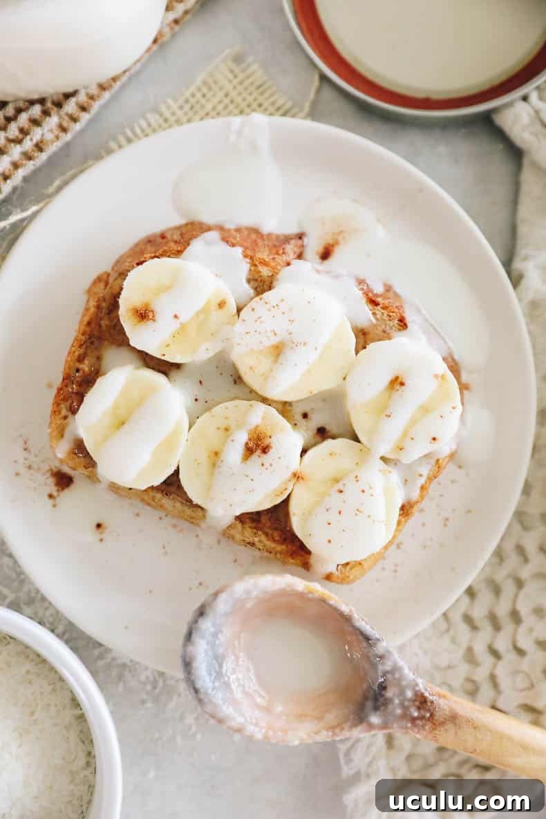 Peanut butter banana toast with homemade coconut butter drizzled on top.