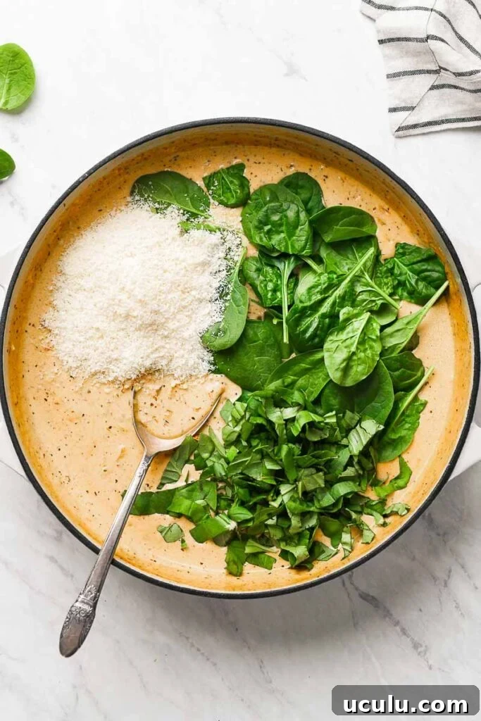 parmesan and spinach added to the creamy sauce