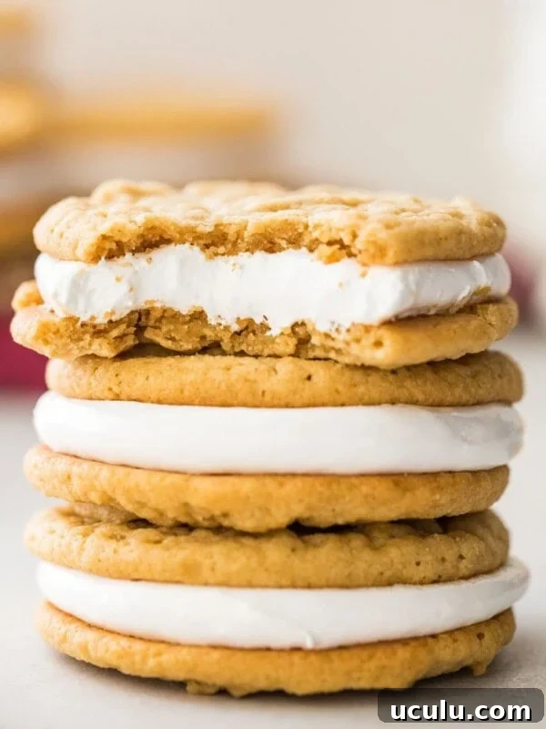 three stacked fluffernutter cookies, with the top cookie missing a bite