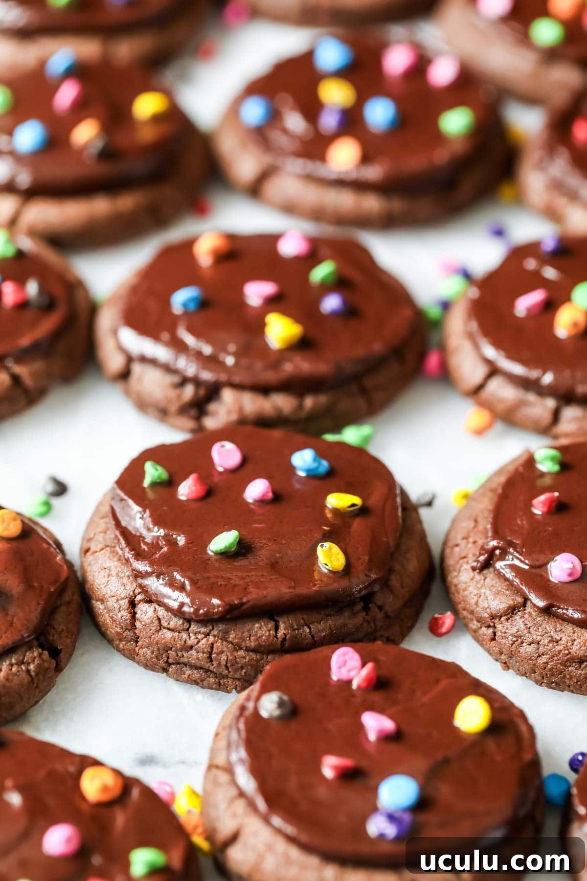 Chocolate cookies topped with fudge frosting and colored candy chips to look like cosmic brownies.
