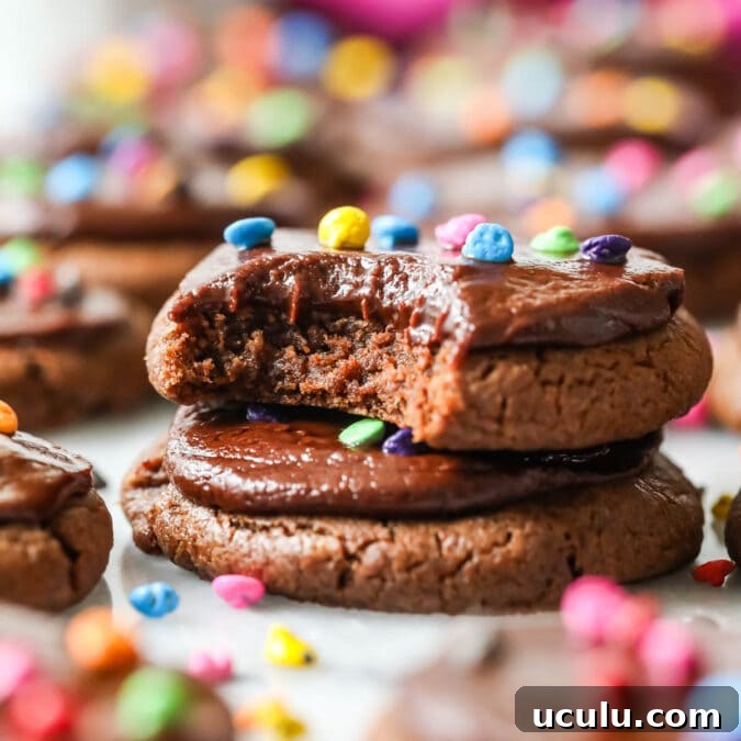 Two cosmic cookies stacked on top of each other with the top cookie missing a bite.