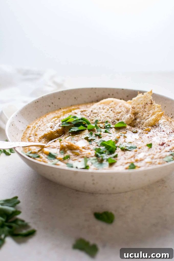 bowl of roasted butternut squash and cauliflower soup with coconut milk