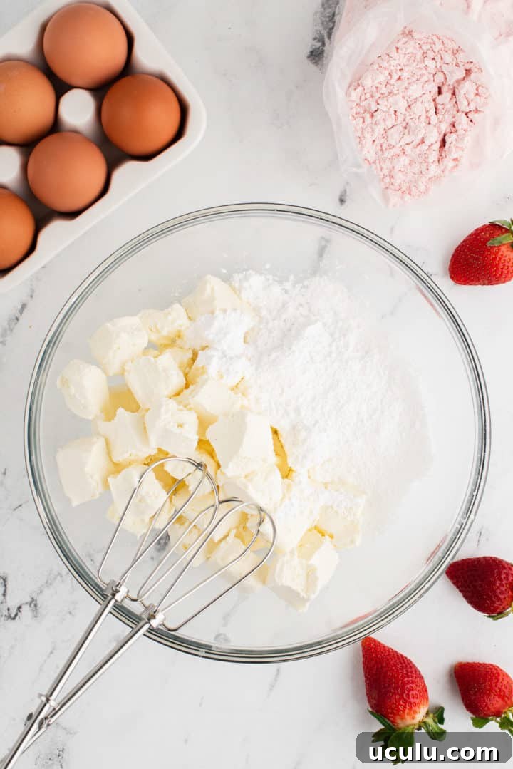 Cream cheese and powdered sugar in a bowl.